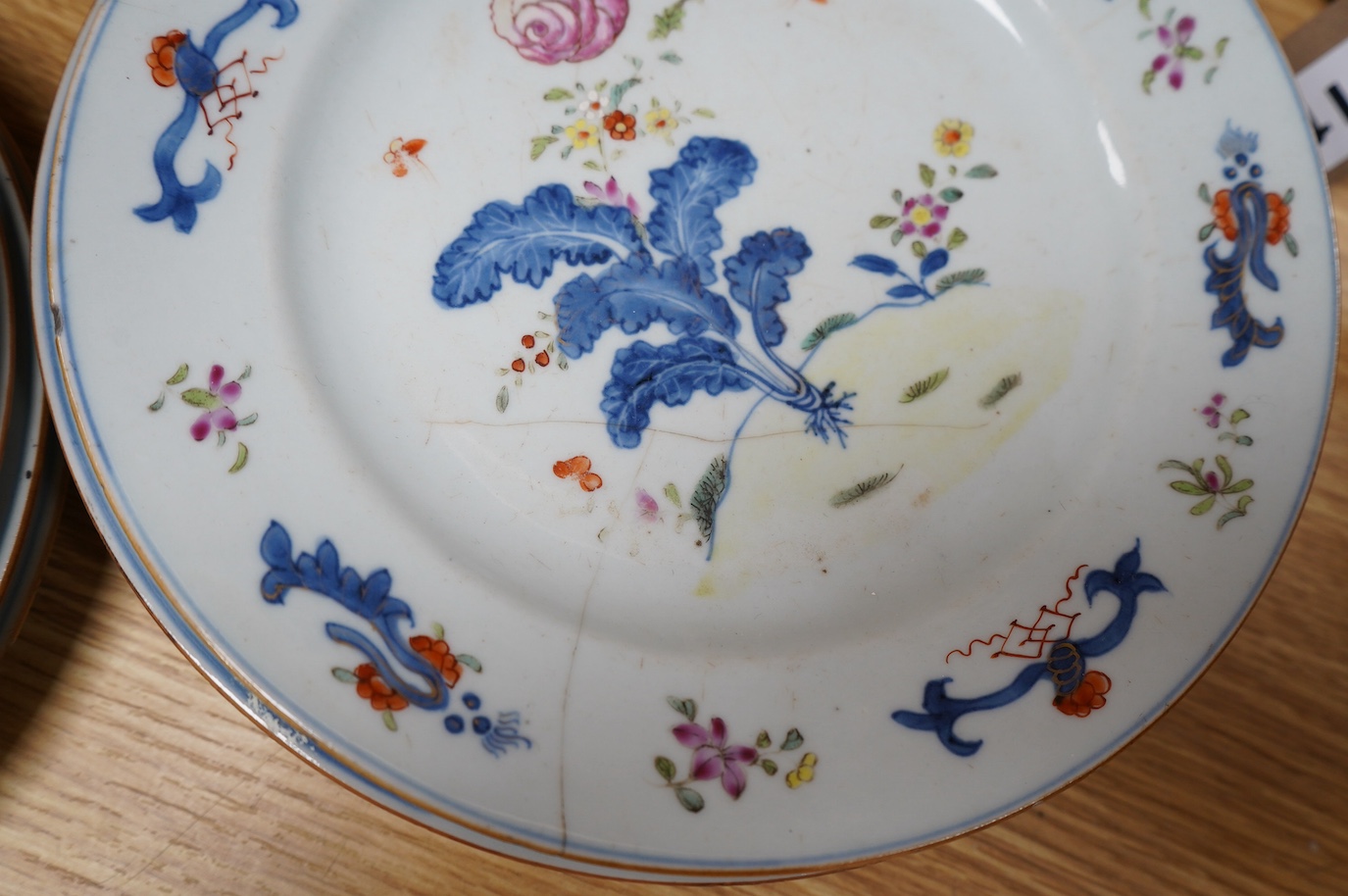 A set of eleven Chinese porcelain ‘’tobacco leaf’’ dishes, (3 cracked), 23cm diameter. Condition - poor.